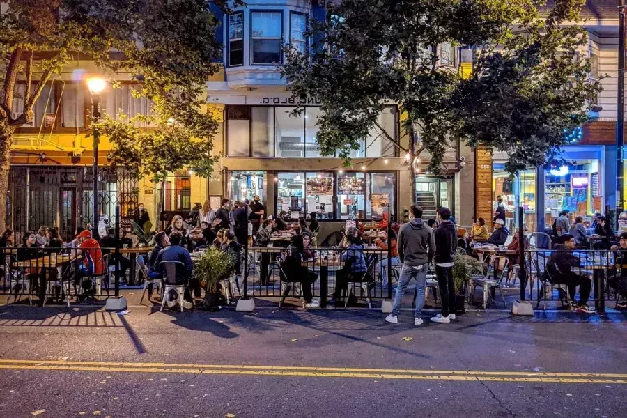 A crowd enjoys food and drink along San Francisco's Valencia Street